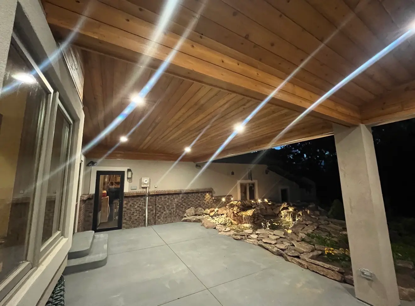 Covered patio ceiling and long concrete area under cascade roof cover in Boulder Colorado