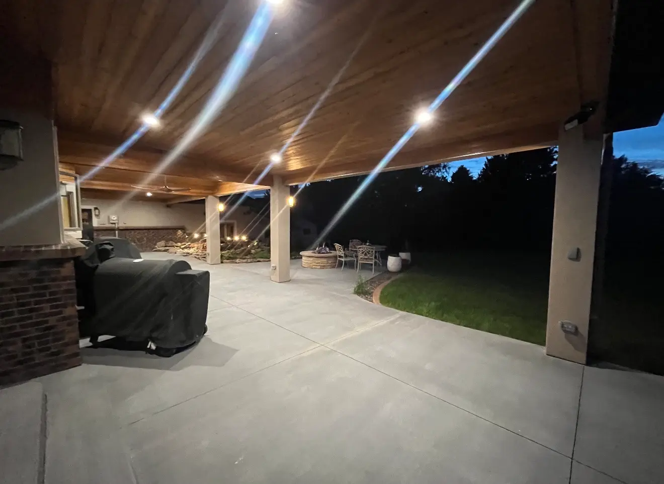 Covered patio area at dusk with open concrete space in Boulder Colorado