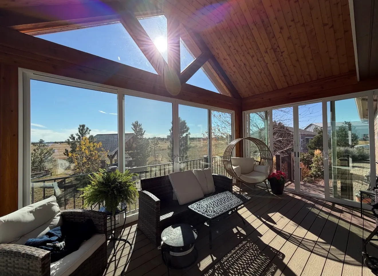 Interior view of elevated sunroom with sunlight and seating in Elizabeth Colorado