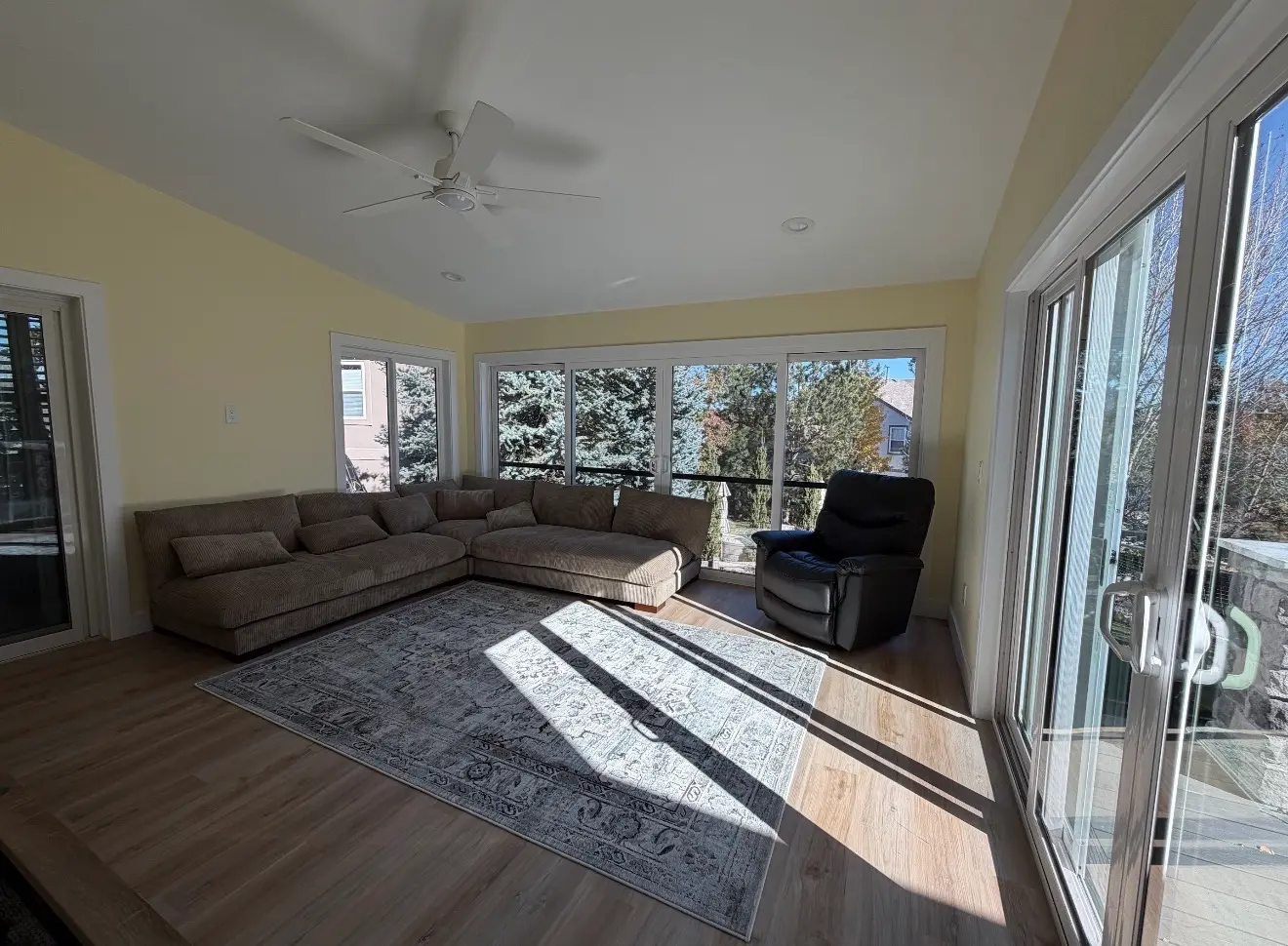 Interior of elevated second-story sunroom with large windows in Aurora Colorado